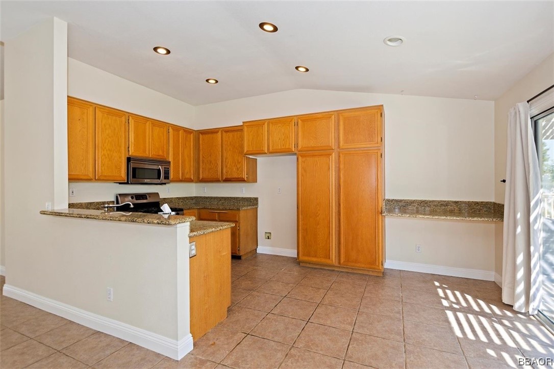 8476 Yarrow Lane Riverside, CA 92508 - Photo 8 of 27 a kitchen with stainless steel appliances granite countertop a refrigerator and a stove top oven