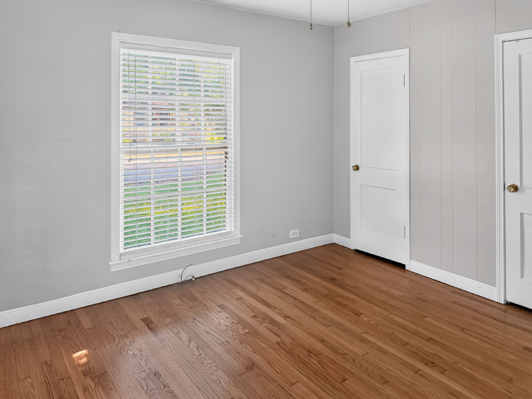 2313 Avenue L Rosenberg, TX 77471 - Photo 20 of 31 Spacious bedroom featuring hardwood floors, a large window, and a generous closet for ample storage.
