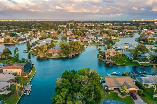 an aerial view of residential houses with outdoor space and lake view