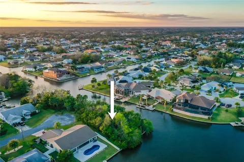 an aerial view of residential house with outdoor space and lake view in back