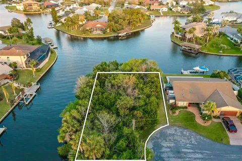 an aerial view of a house with swimming pool having outdoor seating