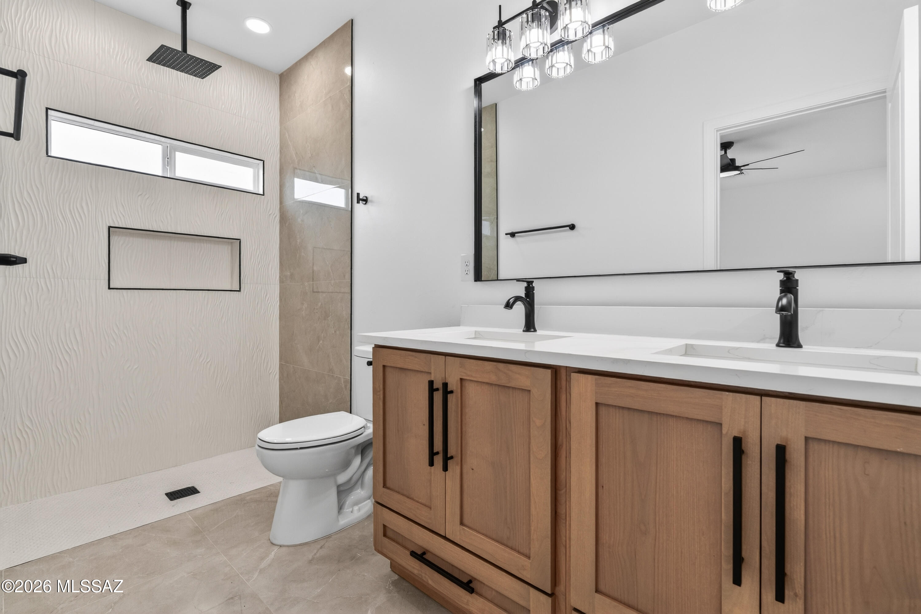 1834 Circulo Glorieta Rio Rico, AZ 85648 - Photo 20 of 35 a bathroom with a sink a toilet a mirror and shower