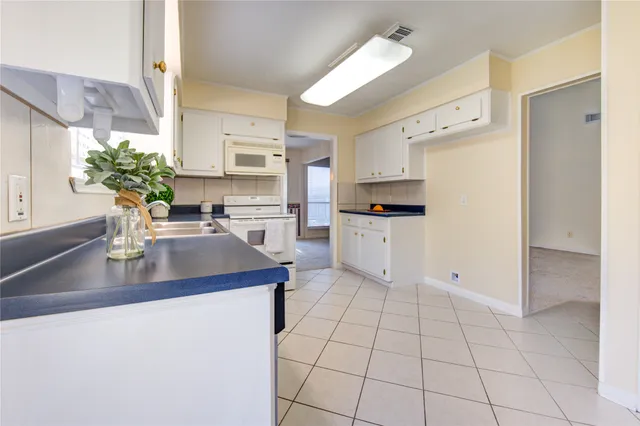 a kitchen with stainless steel appliances a sink stove and cabinets