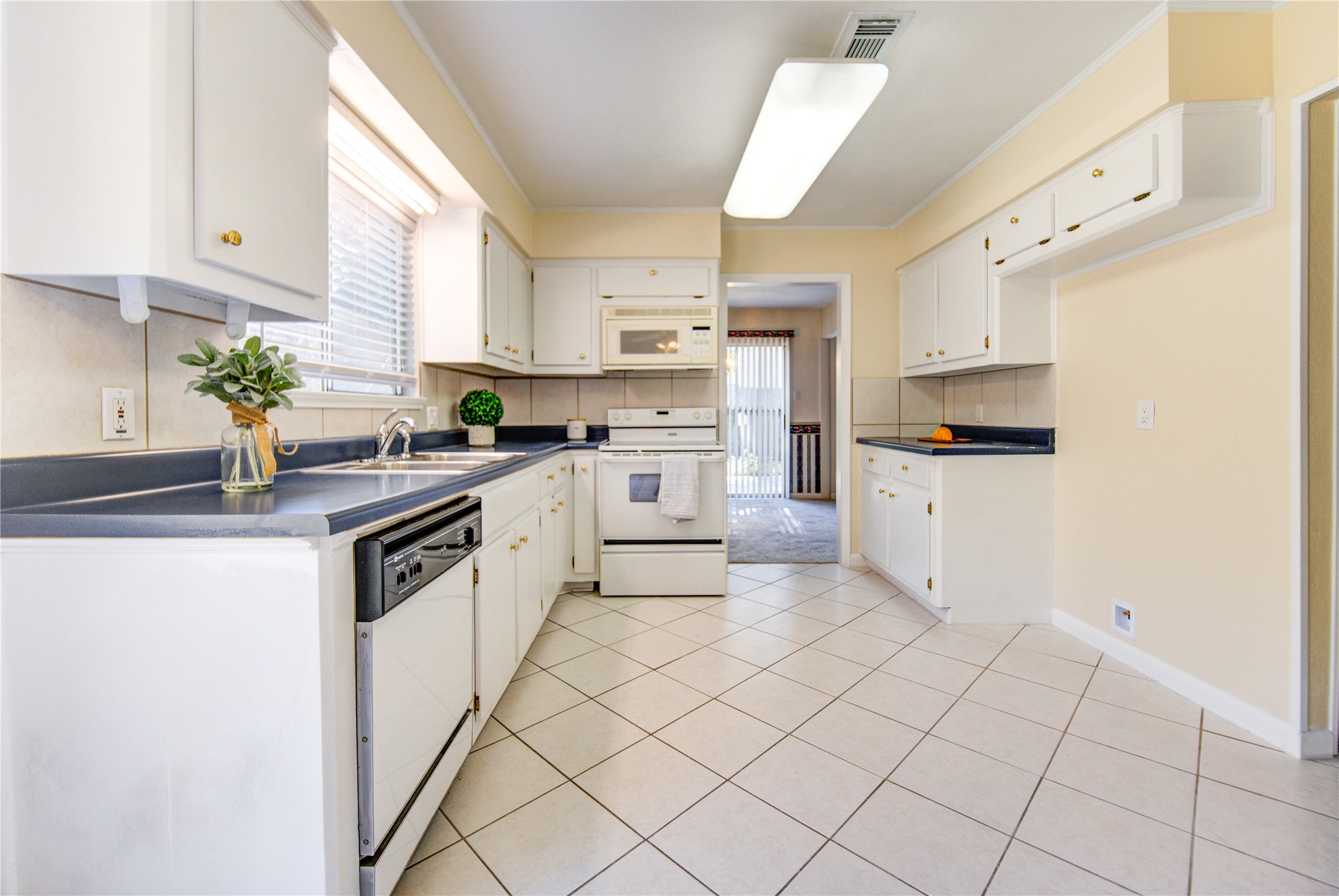 1927 Ash Meadow Drive Houston, TX 77090 - Photo 15 of 50 a kitchen with granite countertop white cabinets and white appliances