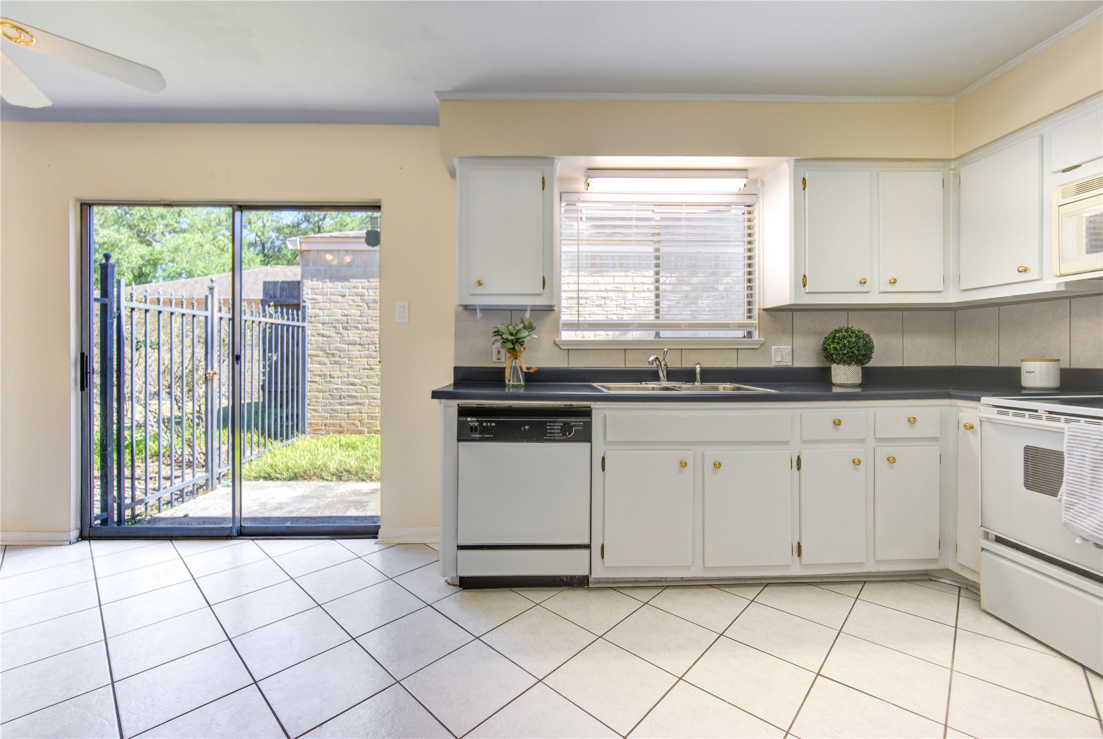 1927 Ash Meadow Drive Houston, TX 77090 - Photo 17 of 50 a kitchen with a sink window and cabinets
