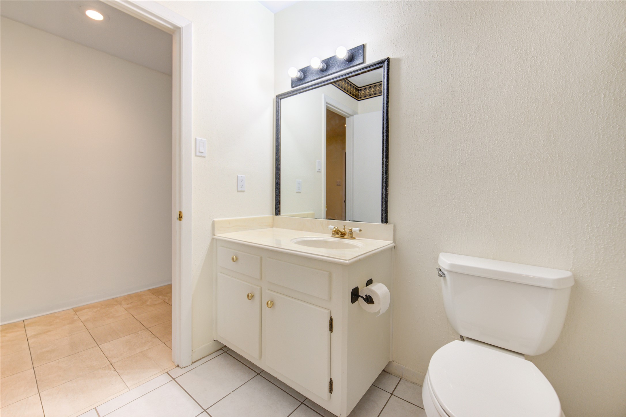 1927 Ash Meadow Drive Houston, TX 77090 - Photo 20 of 50 a bathroom with a toilet sink and mirror