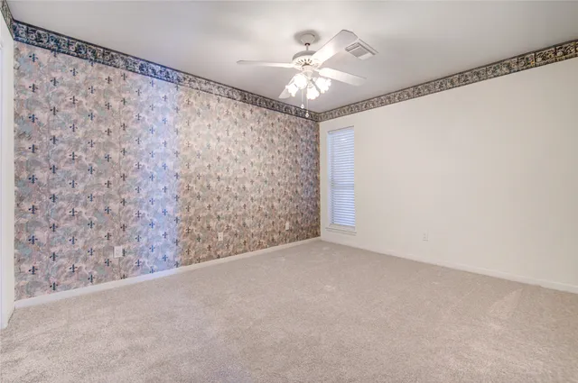 a view of a livingroom with a ceiling fan and window