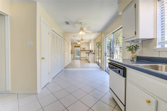 a large white kitchen with cabinets