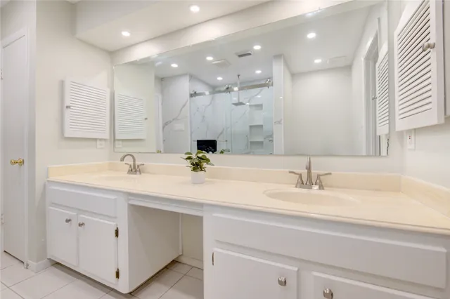 a bathroom with a sink double vanity and a mirror