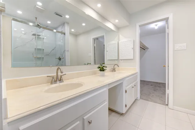 a bathroom with a sink double vanity and a mirror