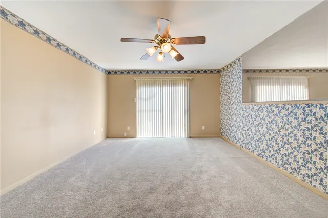 a view of an empty room with a window