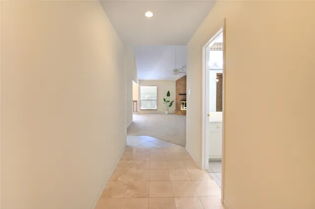 a view of a hallway with a view of living room