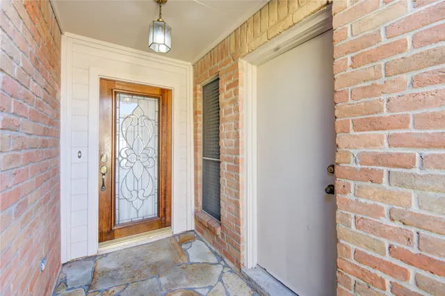 a view of entryway with a front door and wooden floor
