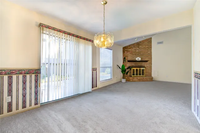 a view of a room with window chandelier fan