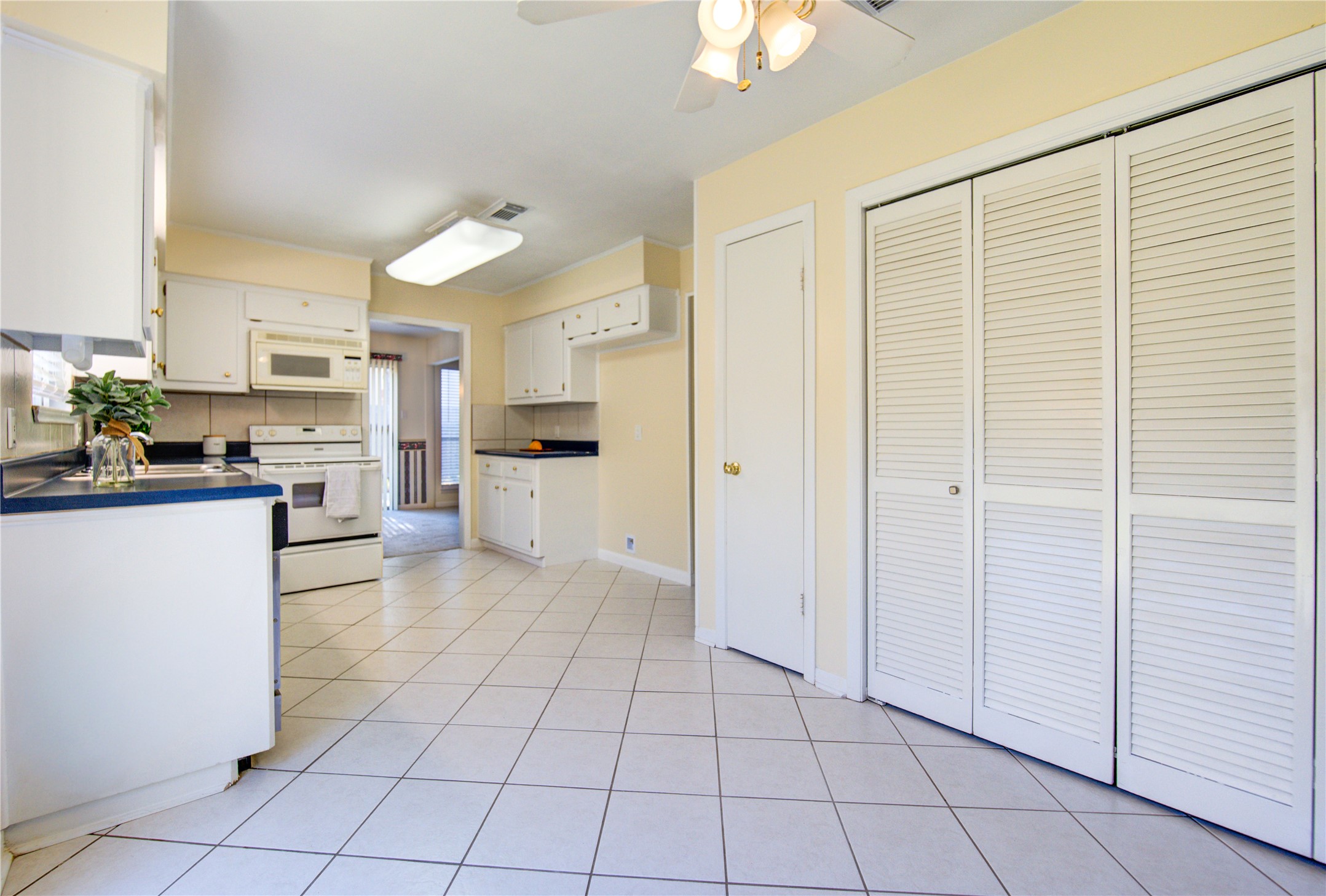 1927 Ash Meadow Drive Houston, TX 77090 - Photo 10 of 50 a view of a kitchen with a sink and a refrigerator