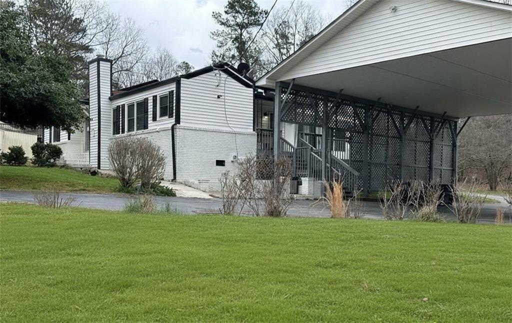 4641 Due W Road Northwest Kennesaw, GA 30152 - Photo 1 of 38 a view of a house with a yard and sitting area