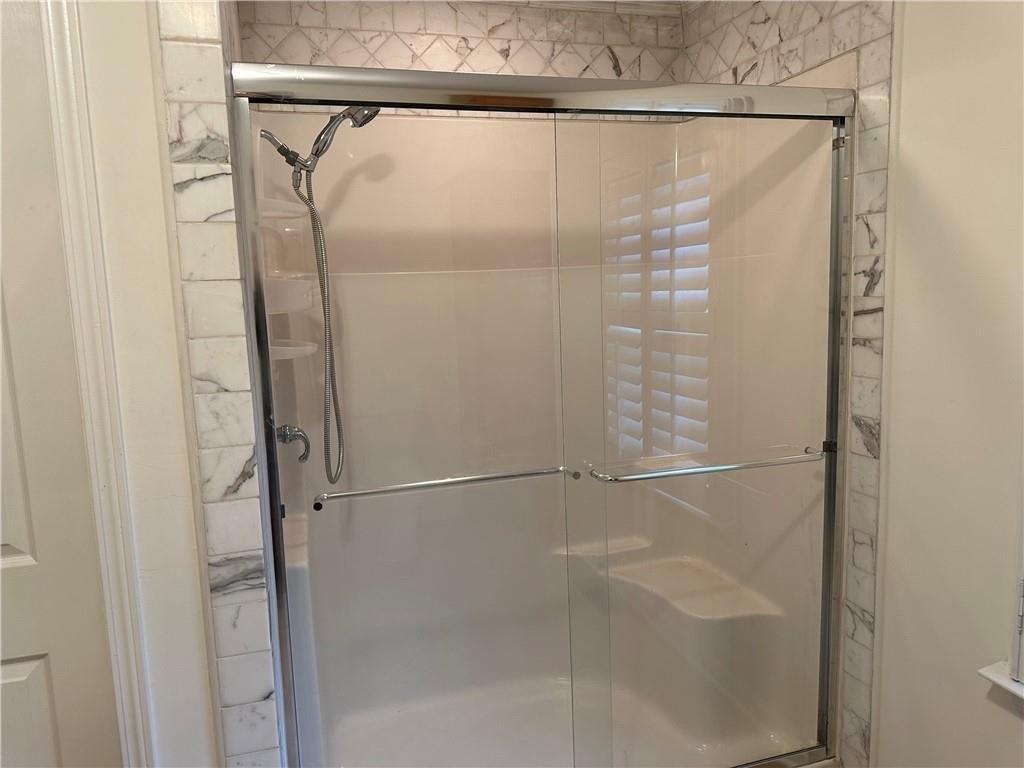 4641 Due W Road Northwest Kennesaw, GA 30152 - Photo 15 of 38 a bathroom with a glass shower door