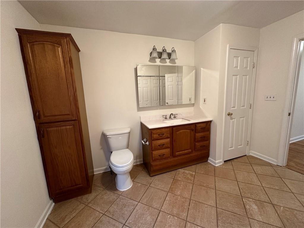 4641 Due W Road Northwest Kennesaw, GA 30152 - Photo 16 of 38 a bathroom with a sink a toilet and shower