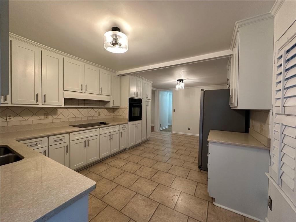 4641 Due W Road Northwest Kennesaw, GA 30152 - Photo 7 of 38 a large kitchen with cabinets and stainless steel appliances
