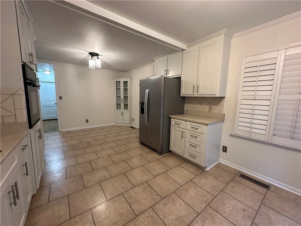 4641 Due W Road Northwest Kennesaw, GA 30152 - Photo 9 of 38 a kitchen with stainless steel appliances a refrigerator and a stove