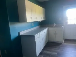 a kitchen with a sink cabinets and a window