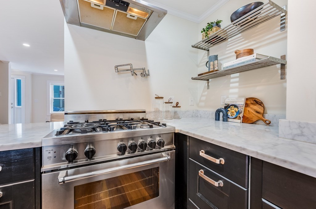 73 Gore Street Cambridge, MA 02141 - Photo 14 of 41 a white stove top oven sitting inside of a kitchen