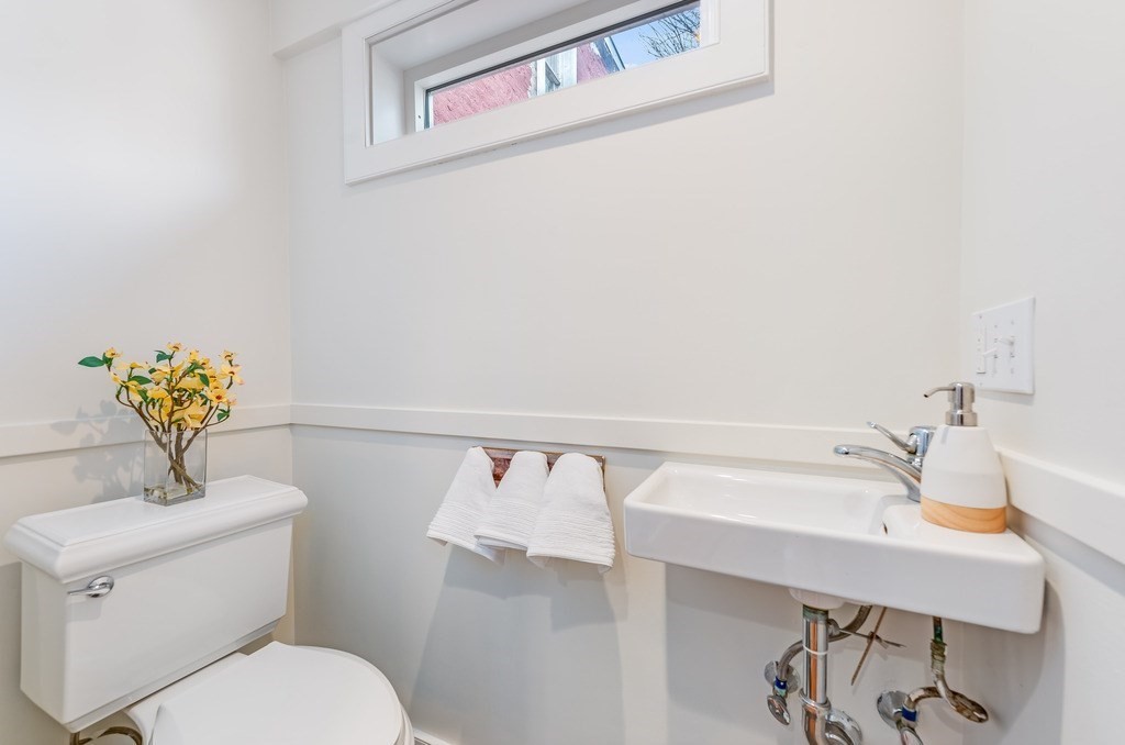73 Gore Street Cambridge, MA 02141 - Photo 19 of 41 a bathroom with a sink a toilet and mirror