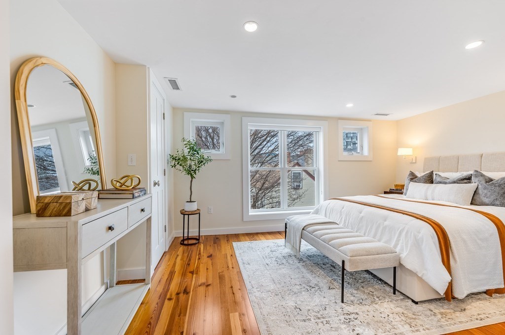 73 Gore Street Cambridge, MA 02141 - Photo 21 of 41 a spacious bedroom with a bed and a couch