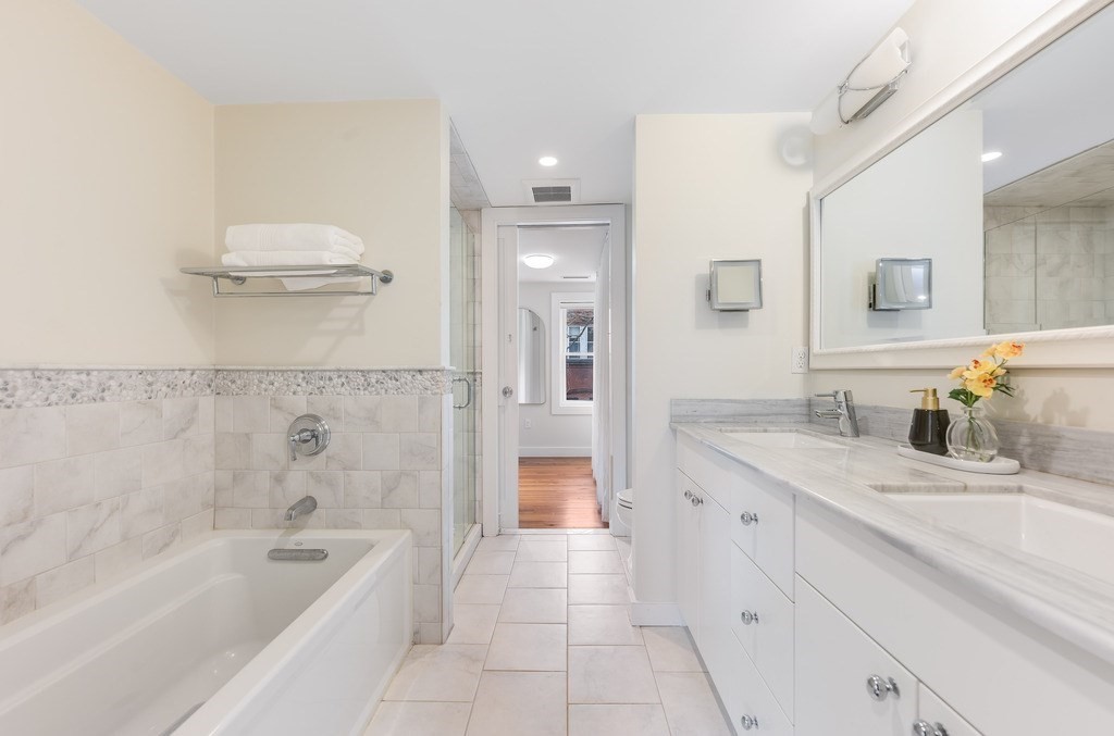 73 Gore Street Cambridge, MA 02141 - Photo 23 of 41 a bathroom with a granite countertop sink a toilet and bathtub