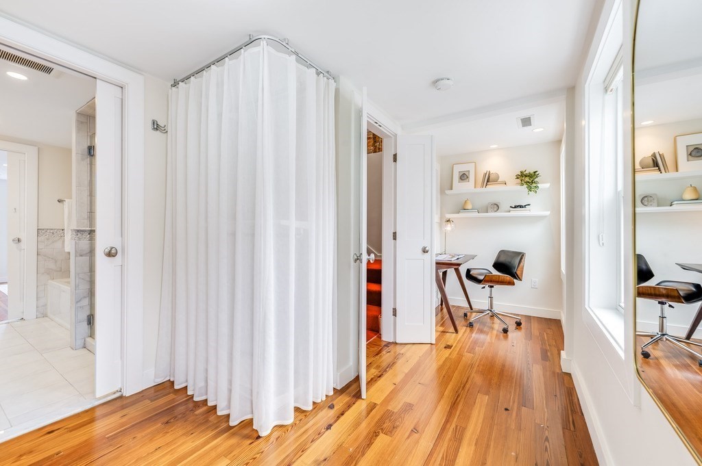 73 Gore Street Cambridge, MA 02141 - Photo 26 of 41 a view of a bedroom with wooden floor and furniture