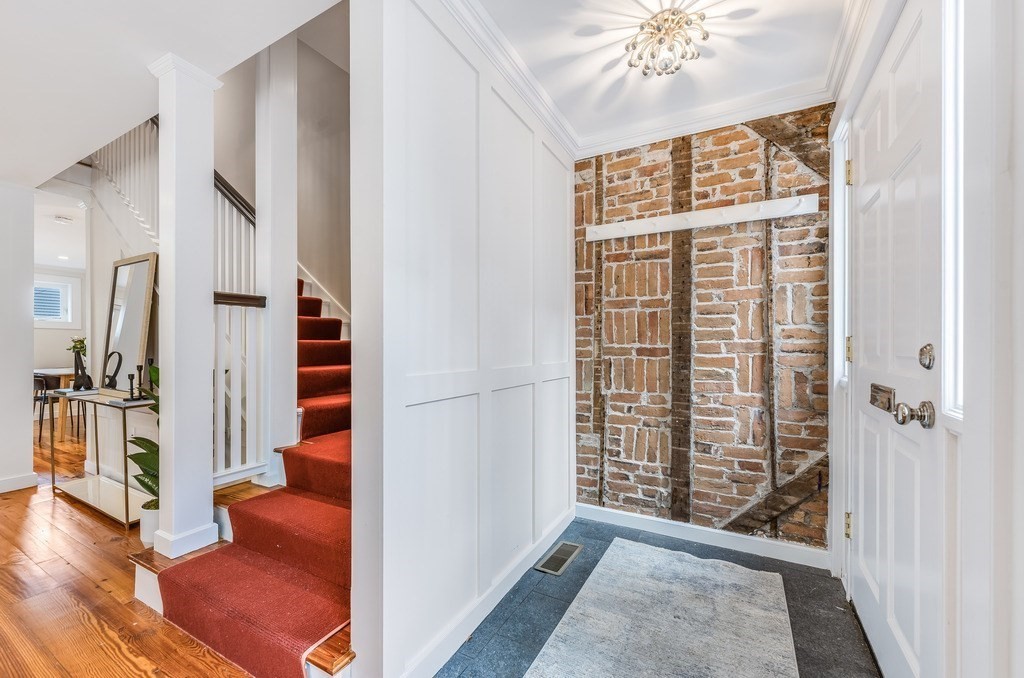 73 Gore Street Cambridge, MA 02141 - Photo 3 of 41 a view of an entryway with wooden floor and a livingroom