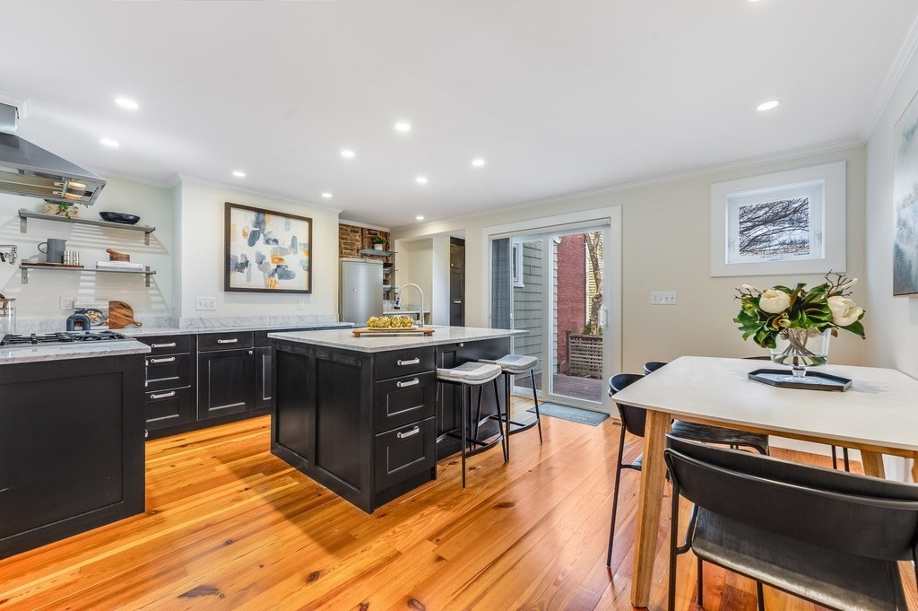 73 Gore Street Cambridge, MA 02141 - Photo 9 of 41 a kitchen with stainless steel appliances granite countertop a stove a sink a refrigerator and a dining table
