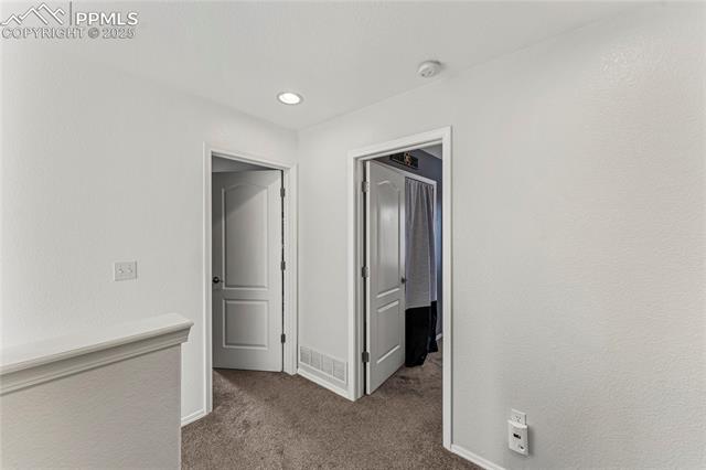 10158 Angeles Road Peyton, CO 80831 - Photo 15 of 43 Hallway with recessed lighting, carpet flooring, visible vents, and baseboards