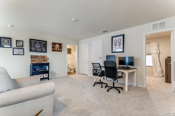 a view of a livingroom with workspace and a couch
