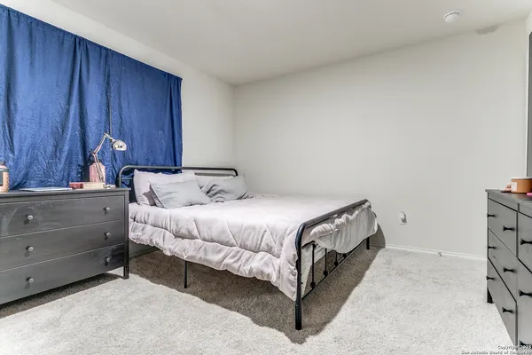 a bedroom with a bed and cabinet