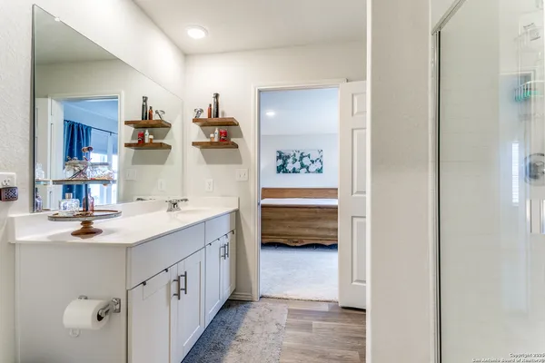 a en suite bathroom with a double vanity sink a mirror and a