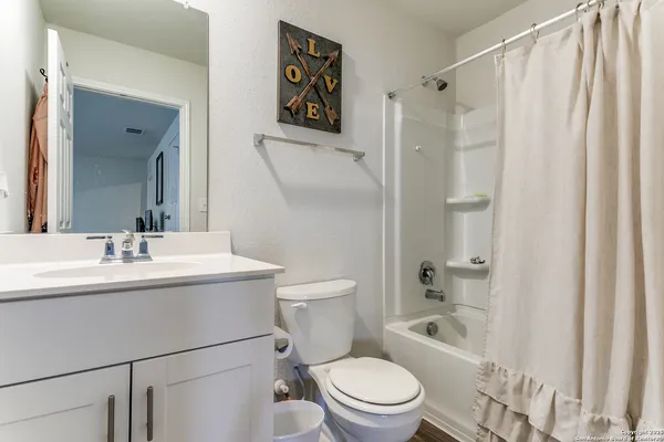 a bathroom with a toilet a sink and a mirror