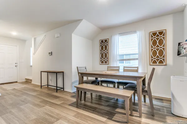 a view of a dining room with furniture and window
