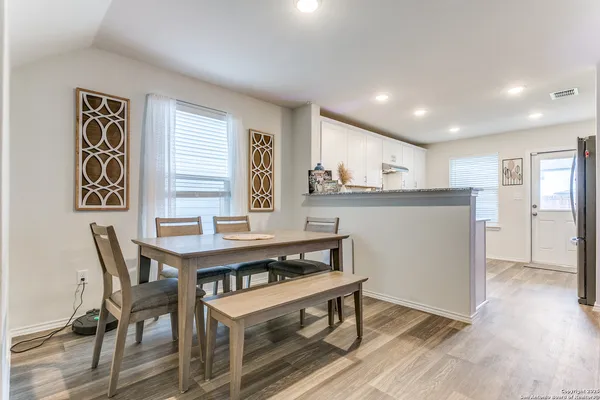 a kitchen with a table and chairs in it