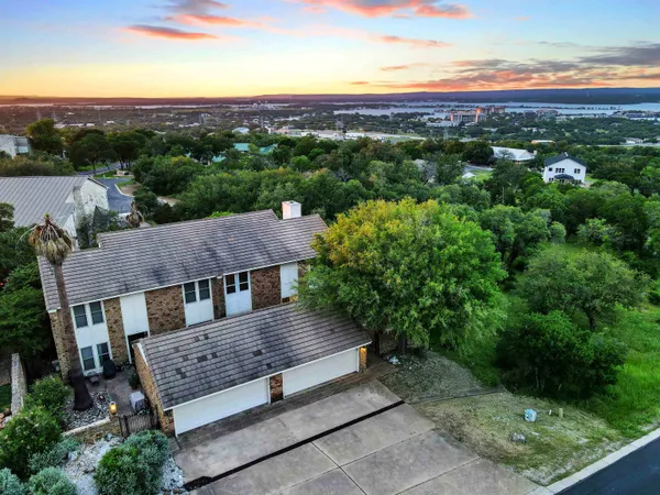 an aerial view of a house with a yard