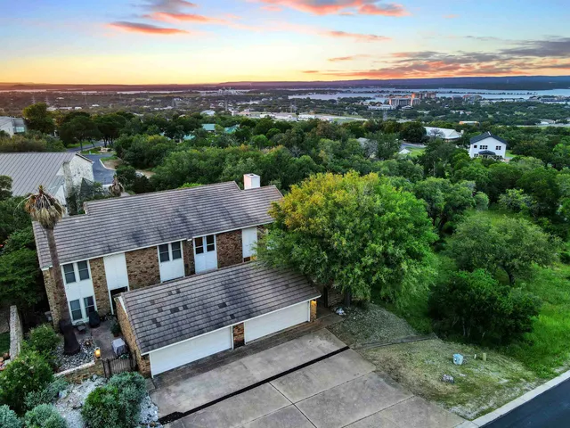 an aerial view of a house with a yard
