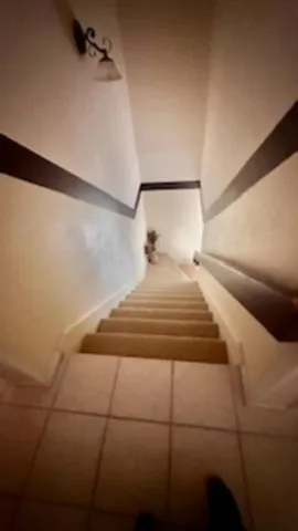 a bedroom with a bed and a night stand