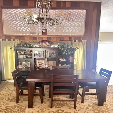 a view of a dining room with furniture and window