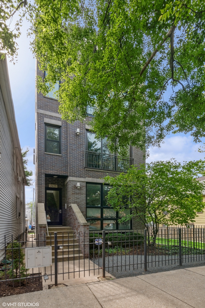 2425 West Homer Street, Unit 3 Chicago, IL 60647 - Photo 1 of 1 a front view of a house with a garden