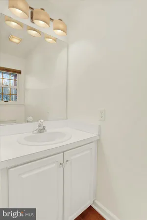 a bathroom with a sink vanity and mirror