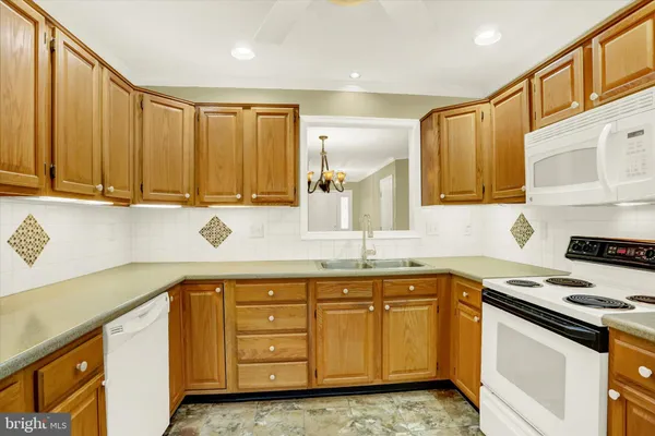 a kitchen with a sink stove top oven and cabinets