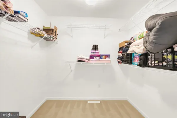 a view of storage and utility room with two washing machine