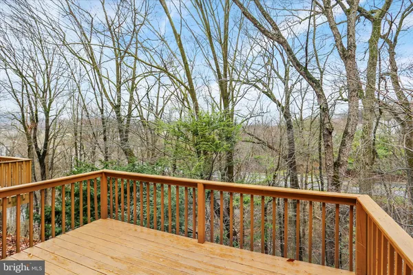 a view of balcony with wooden fence and floor