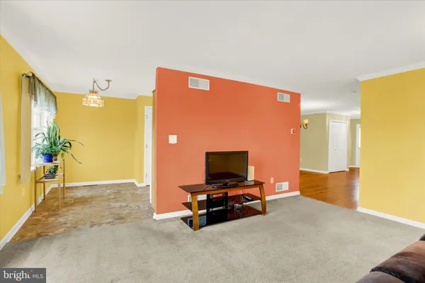 a living room with furniture pool table and a flat screen tv