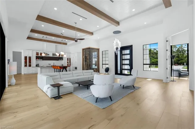 a living room with furniture and view of kitchen